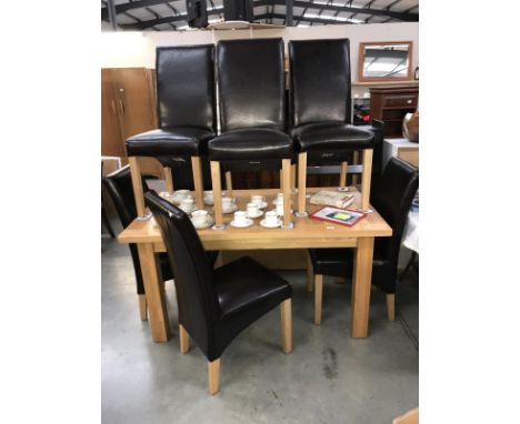 A solid oak dining table &amp; 6 leather chairs