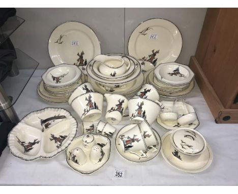 A Midwinter windmill decorated dinner service.