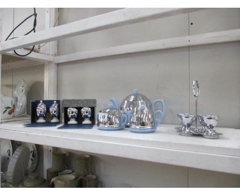 An art deco heatmaster 3 piece teaset, 2 boxed sets of egg warmers and a 4 cup egg stand
