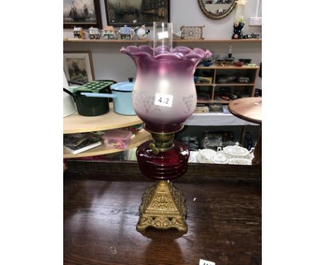 An oil lamp with ruby glass font