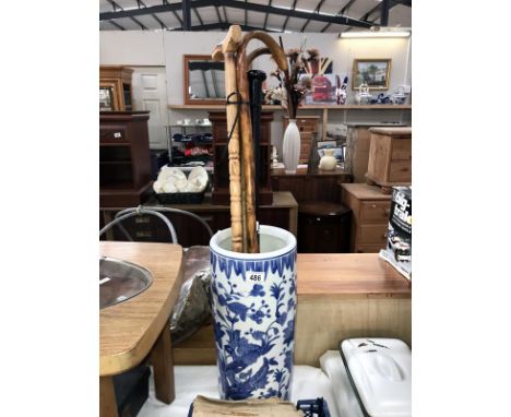 A blue &amp; white stick/umbrella stand &amp; contents