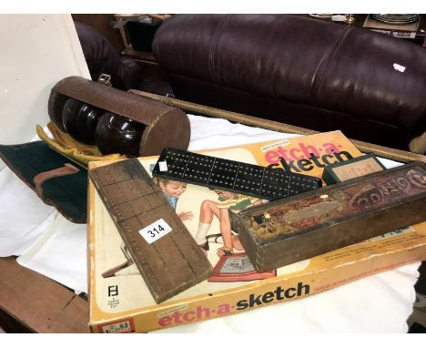 A mixed lot of games including cribbage boards, bowls, dominoes and etch-a-sketch.