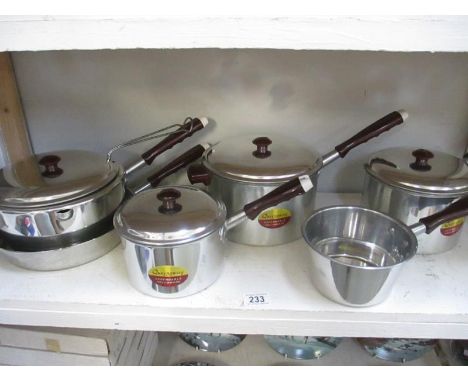 A quantity of vintage stainless steel saucepans