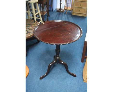 A mahogany tripod table