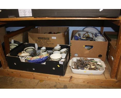 A shelf of assorted tea china, cutlery etc.