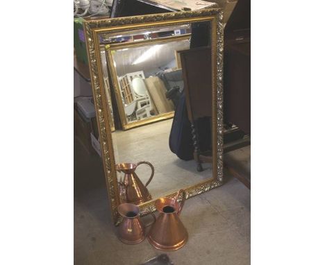 A gilt mirror, two copper jugs,a very large print of roses and a small wooden stand 