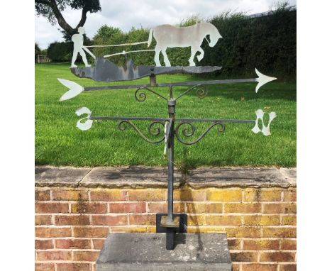 A painted steel weather vane with horse and plough detail and N, E, S and W denominations, with wall mounting bracket, 118cm 
