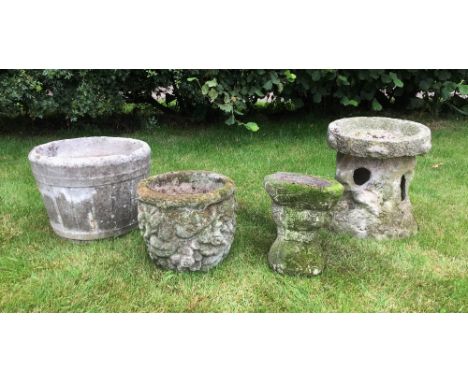 A selection of four decorative reconstituted stone garden items, to include a coopered jardiniere, a two sectional bird bath,