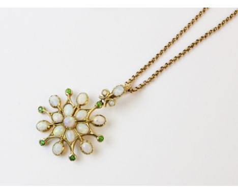 An early 20th century opal and demantoid garnet pendant, the starburst design pendant set with polished opal cabochons inters