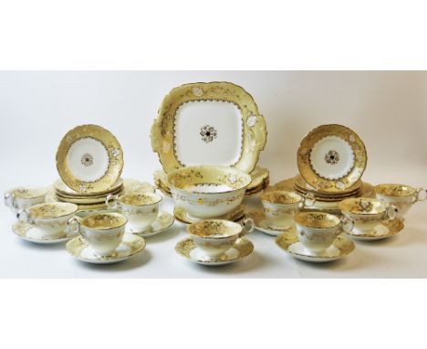 A Victorian Rockingham style tea service, 49 pieces, decorated with trailing gilt vinery on an ivory ground, comprising; tea 