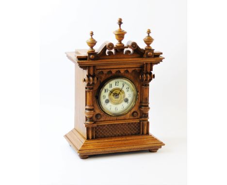 An early 20th century German oak cased bracket clock, by the Hamburg American Clock Co. the golden oak architectural case wit