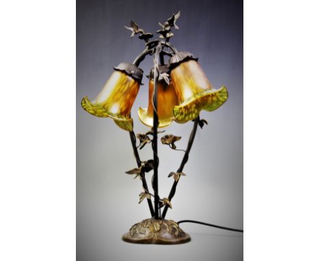 An Art Nouveau style triple table lamp, late 20th century, the cast brass base with foliate scrolling vine motif, supporting 