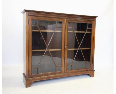 An Edwardian mahogany display cabinet by Maple &amp; Co, London, the rectangular cross banded top above two astragal glazed d