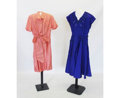 A mid 20th century electric blue a-line dress with corded and pearl bead detail to the neckline, with waist belt, a coral pin