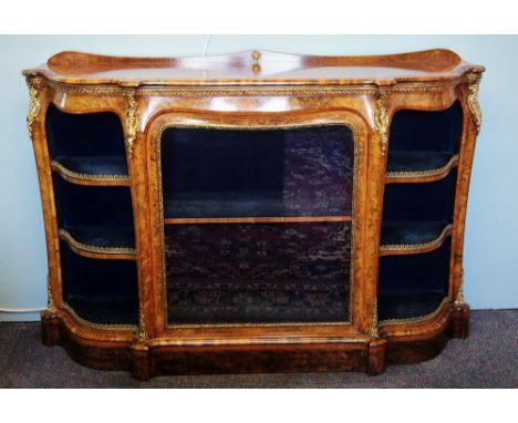 A Victorian burr walnut credenza, the shaped moulded top with satinwood cross banding, above a gilt metal stiff leaf frieze a