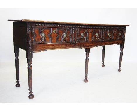 A 17th century and later oak dresser, the rectangular moulded two plank top above three geometrically moulded drawers applied