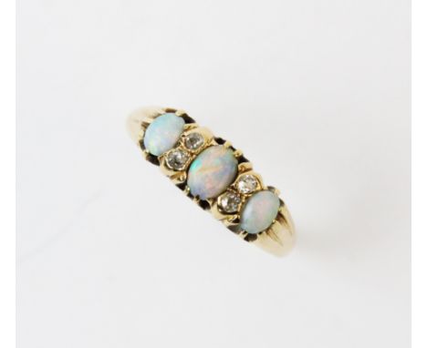 An opal and diamond ring, the three graduated oval opals, interspersed with four old cut diamonds, all claw set in 18ct yello