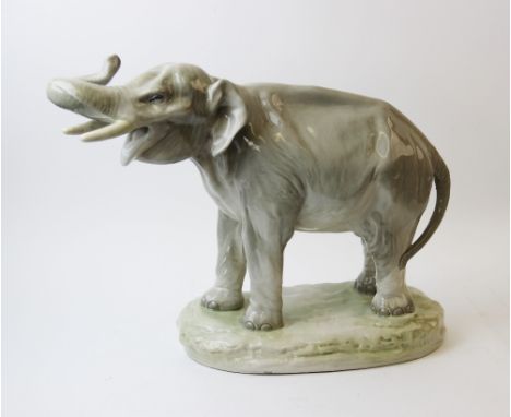 A large Czecho-Slovakia Amphora bull elephant, the celadon glazed elephant modelled standing with its trunk raised, impressed