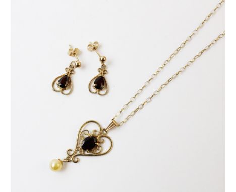 A suite of garnet set jewellery, comprising a garnet set yellow metal pendant, comprising a central oval mixed cut garnet mea