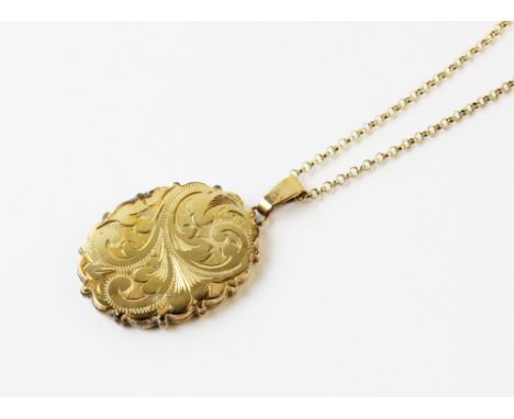 A 9ct gold locket pendant, the oval pendant with scalloped borders and engraved scrolling decoration to front, two vacant com