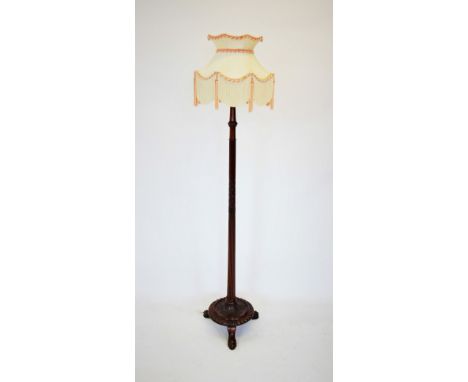 A Regency style mahogany lamp standard, the reeded column with carved ribbon detail, upon a circular plinth base with a gadro