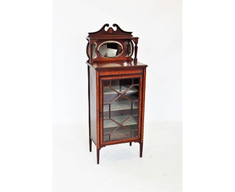 An Edwardian mahogany music cabinet, the raised architectural back with a twin swan neck pediment above a single shelf and a 