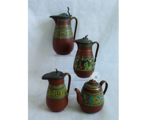 A set of three graduated Prattware lidded jugs, with Greek Key decoration on a terracotta ground, together with a similar tea
