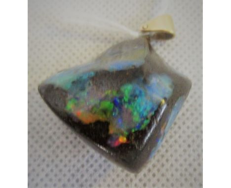 A boulder opal pendant, the rough cut stone to simple yellow metal bale, overall weight 25.2g. Condition Report: Drop 33mm.  