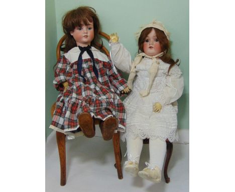 2 German bisque head dolls with jointed composition bodies; taller doll height 78cm has closing brown eyes, open mouth with t