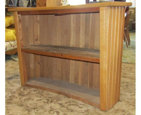 A light oak cocktail/drinks bar of curved form with vertical slatted surround, open back with fixed shelf, 130 cm wide x 40 c