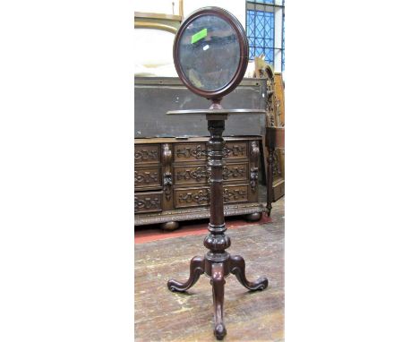 Victorian mahogany shaving stand, the circular mirror set on an adjustable column above a circular platform raised on a vase 