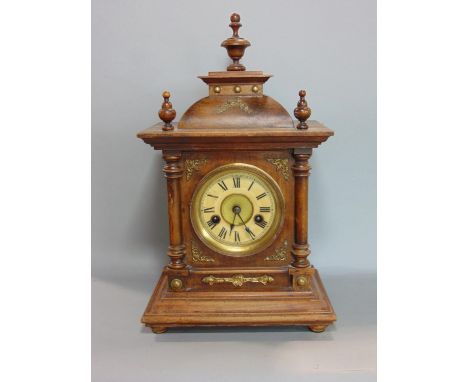 A late 19th century Wurttemberg 14 day striking mantle clock, the case with applied brass mounts sat beneath 3 turned finials