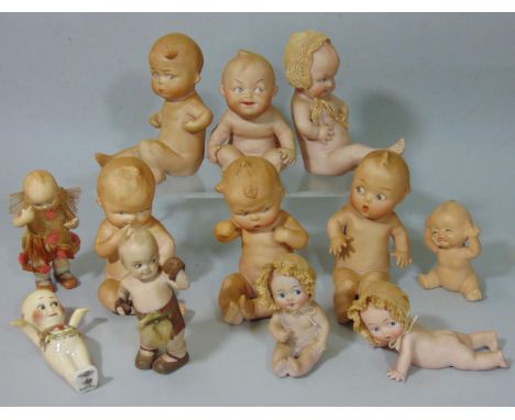 12 all bisque Kewpie type ornamental doll figures, all with side glancing eyes and in various character poses, mostly German 