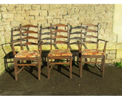 A pair of dark stained Ercol elm and beechwood ladderback carver chairs with slatted seats together with a matching single ex