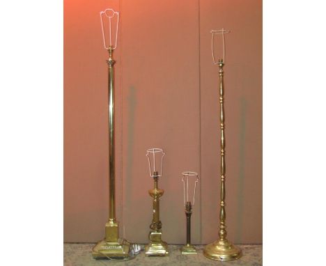 A brass effect standard lamp in the form of a Corinthian column with stepped base and paw feet, one other and two table lamps