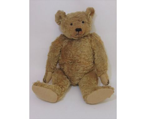 An early bear, circa 1930's, probably Merrythought, with boot button eyes, a weak growl, golden mohair plush, long clipped sn