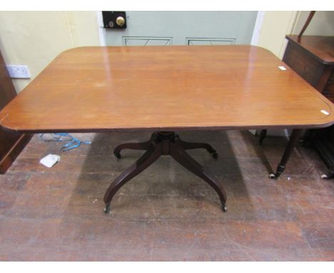 A Regency mahogany breakfast table, the rectangular top to seat four, raised on a turned pillar and quadruped base 