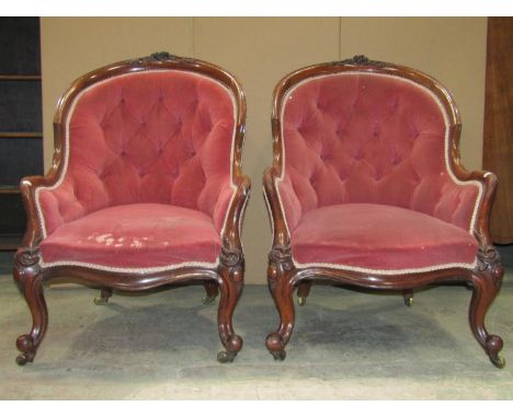 A pair of Victorian spoonback drawing room chairs with upholstered seat, button back and arms within showwood frames with car