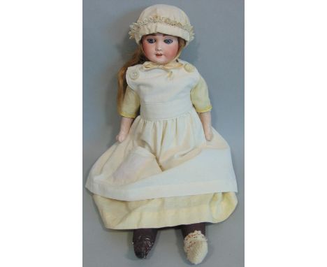 French shoulder head bisque doll by Laternier with soft stuffed body and legs, and bisque lower arms. Blue sleeping eyes and 