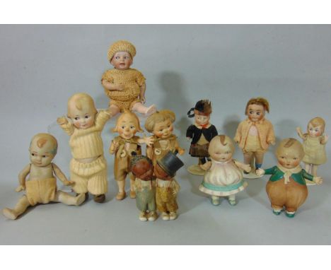 Collection of 8 small all bisque dolls with jointed bodies and side glancing eyes including a pair of German character dolls 