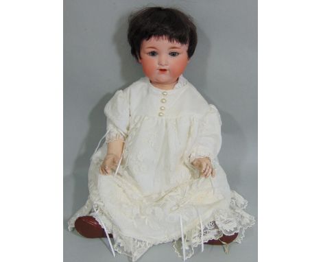 1920's Armand Marseille Baby Doll with bisque socket head and composition body with bent limbs. Blue closing eyes, open mouth