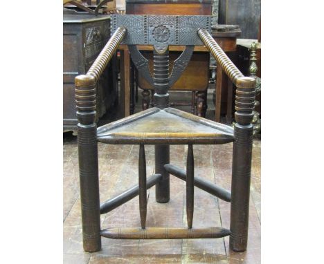 Antique turners chair of usual form with triangular panelled seat, bobbin moulded support and carved back rail 