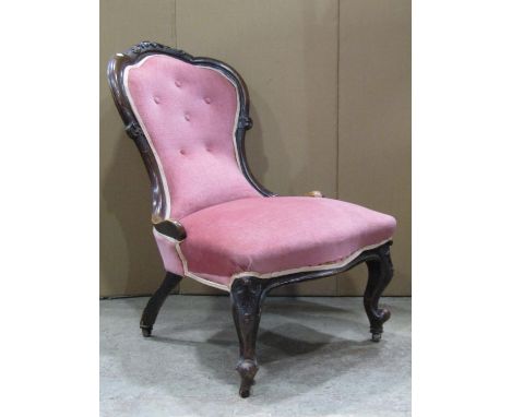 A Victorian ladies spoonback drawing room chair with serpentine upholstered seat and button back within a showwood frame rais