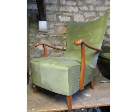 A vintage open armchair with deep sprung upholstered seat and winged button back over shaped arms and simple turned tapered s