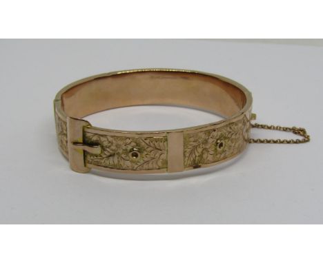Early 20th century 9ct buckle bangle with engraved foliate decoration, 16.9g (af) 