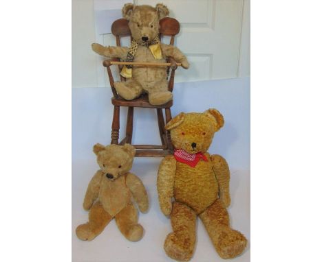 3 vintage teddy bears all with stitched mouth and nose and glass eyes, together with a wooden high chair; largest bear 80cm t