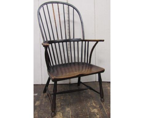 18th century Windsor stick back elbow chair in mixed woods, the elm seat raised on turned supports and turned rails 