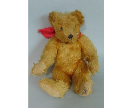 Small 1930's teddy bear 'A Farnell Alpha toy' with golden plush fur and jointed body, pronounced nose and humped back 