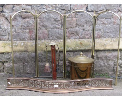 A 19th century brass serpentine fender with pierced geometric and floral grill, together with a cylindrical brass coal bucket