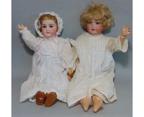 2 German bisque head dolls both with blue sleeping eyes, open mouth with teeth, short fair hair, wearing period white dresses